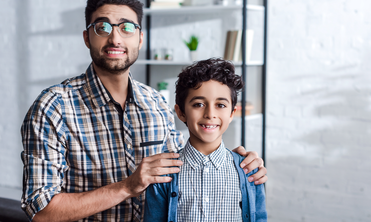 Pai segurando nos ombros do filho representando dependente